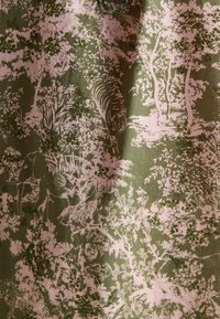 Kangas on roheline taust, millel on roosa, üksikasjalik muster puudest ja loomadest, sealhulgas elevantidest ja tiigrist, klassikalises stiilis.