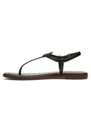 Black leather sandal with a flat sole, thong design, and adjustable ankle strap. Textured brown footbed with subtle pattern.