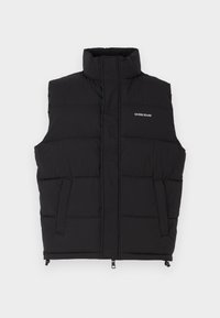 Black puffer vest with a high collar, featuring two side pockets and a front zip closure. Displays "GUESS JEANS" logo in white.
