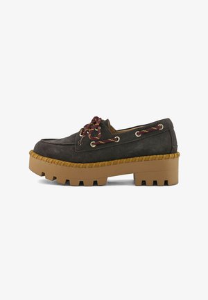 Black suede platform loafer with thick brown rubber sole, chunky tread, and maroon lace details threaded through metal eyelets.