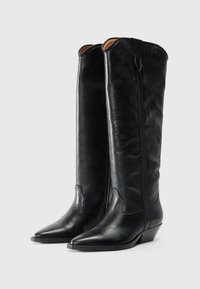 Black leather knee-high boots with pointed toes, textured finish, stitching details, and a low stacked heel. Features a side zipper.