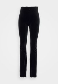 Pantalon en velours noir taille haute, ajusté, avec jambes droites sur un fond uni clair.