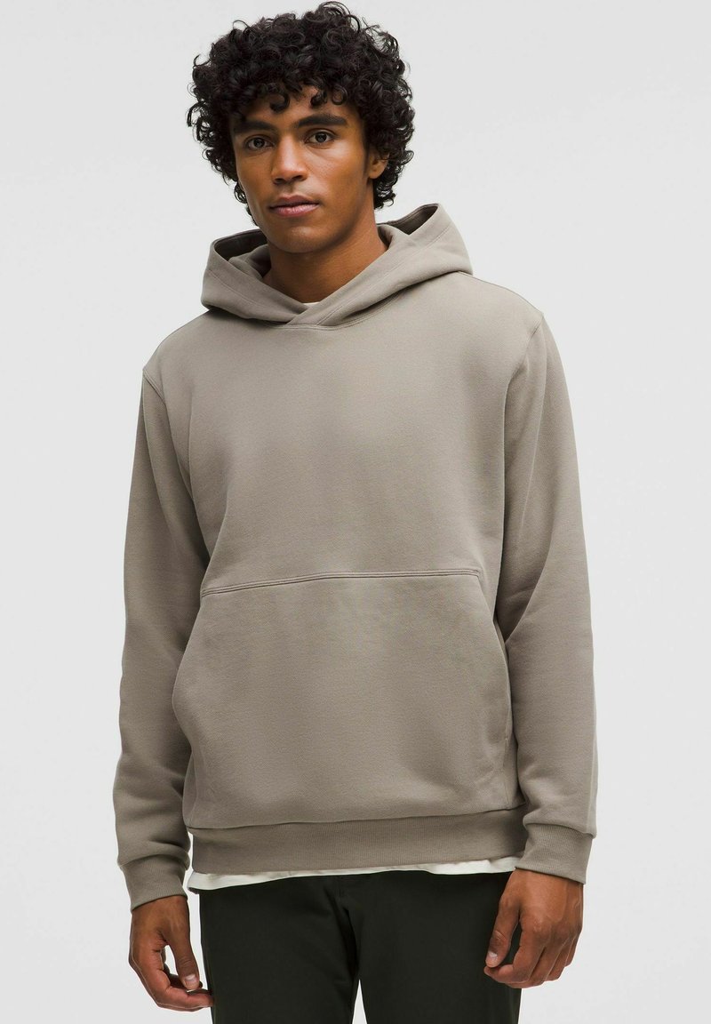 Pullover-Hoodie in sanftem Beige, mit Kängurutasche, verstellbarem Kordelzug in der Kapuze und gerippten Bündchen für eine angenehme Passform.