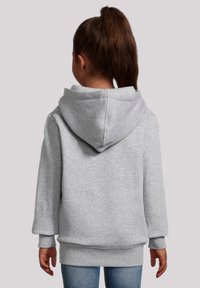 Grijze hoodie met een grote capuchon, losse pasvorm en geribde manchetten. Zachte stoftextuur, zichtbare naden en een licht oversized ontwerp.