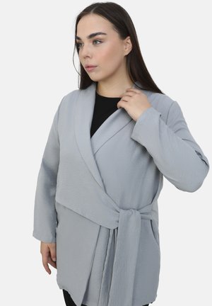 Light gray wrap jacket featuring a textured fabric, long sleeves, and a tied waist. The design includes a deep V-neck and a relaxed fit.