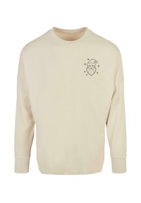 Bežová mikina s dlhým rukávom a okrúhlym výstrihom, s čiernym grafickým motívom tváre Santa Klausa a snehových vločiek v oblasti ľavého hrudníka.