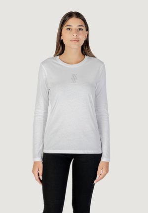 T-shirt bianca a maniche lunghe realizzata in tessuto liscio, con un piccolo dettaglio grafico grigio sul petto e design a girocollo.