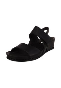 Sandalias de cuña negras con correas cruzadas y punta descubierta. Fabricadas en material sintético suave con un ligero brillo.