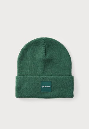 Green knitted beanie with a folded cuff and a rectangular Columbia logo patch in white and teal. Soft texture and simple design.