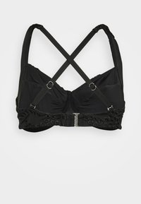 Sutiã preto com design cruzado nas costas, copos almofadados, acabamento decorativo e alças ajustáveis com fecho em metal.