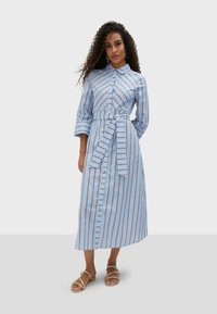 Button-up striped dress in light blue with brown vertical stripes, featuring a belted waist, three-quarter sleeves, and a knee-length cut.