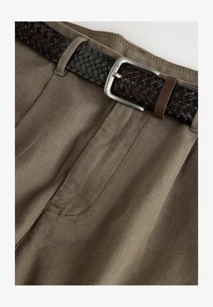 Beige fabric trousers with a textured surface and subtle pleats, paired with a dark braided leather belt featuring a silver buckle.