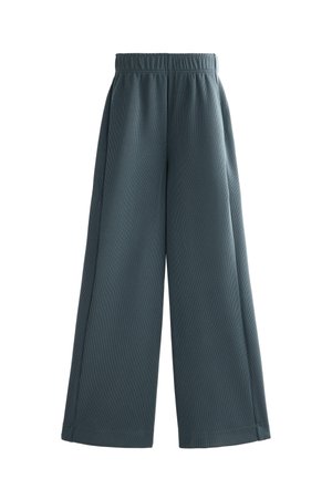Weite Hosen in einem gedämpften Türkis mit gerippter Textur. Verfügt über einen elastischen Bund und einen lockeren Schnitt. Keine sichtbaren Taschen.