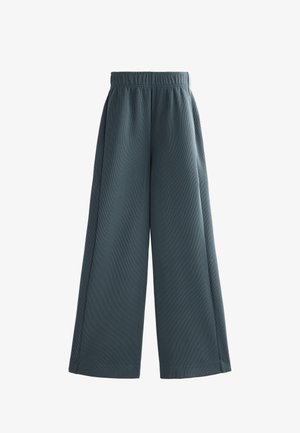 Weite Hosen in einem gedämpften Türkis mit gerippter Textur. Verfügt über einen elastischen Bund und einen lockeren Schnitt. Keine sichtbaren Taschen.