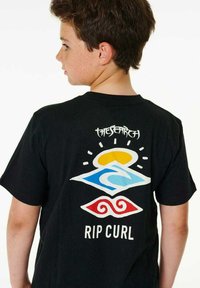 T-shirt noir avec des graphismes colorés : un soleil jaune, une vague bleue, des tourbillons rouges, et le texte "THE SEARCH" et "RIP CURL" au dos.