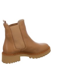 Tan leather ankle boot with elastic side panels, textured rubber sole, and contrasting stitching. Rounded toe and sturdy design.