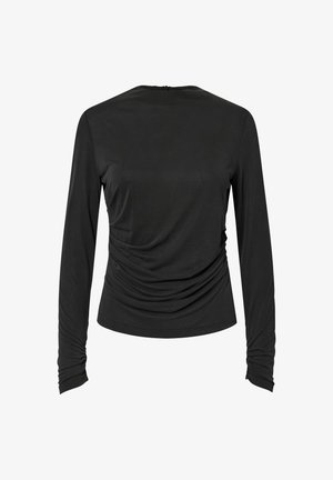 Musta pitkähiha Tunika, jossa on pyöreä pääntie, varustettu kerättyillä sivuilla ja sileällä pinnalla. Yksinkertainen malli ilman metalliosia tai koristeita.