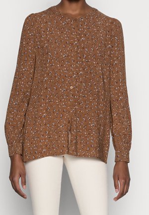 Braune Bluse mit floralem Muster, langen Ärmeln, rundem Ausschnitt, Knopfverschluss und lockerer Passform sowie weißen und blauen Blumenmustern.