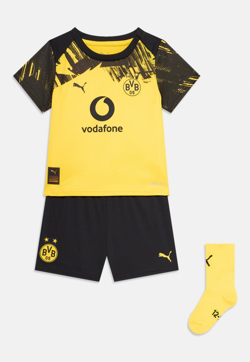 Čierny a žltý mládežnícky futbalový dres obsahuje tričko s krátkym rukávom s logom, šortky a jasne žlté ponožky. Vyrobené z syntetického materiálu.