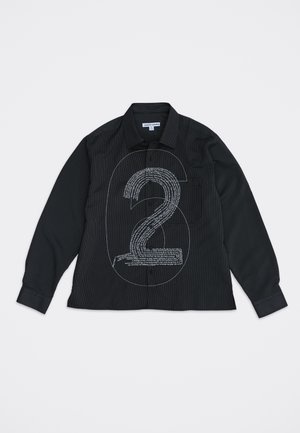 Chemise noire à manches longues avec boutons, ornée d'un grand numéro 6 en contour et d'un design texturé du numéro 2 en texte blanc sur le devant.
