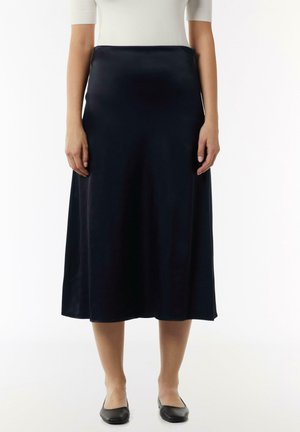 Navy satin midi skirt with a smooth texture, A-line design, and solid color, paired with black flats.