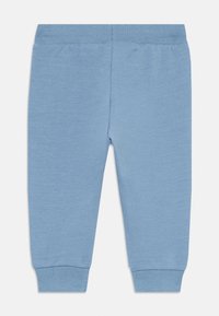 Blaue Baumwoll-Sweatpants mit einem gerippten Bund und Bündchen. Glatte Textur, schmaler Schnitt und keine zusätzlichen Muster oder Verzierungen.