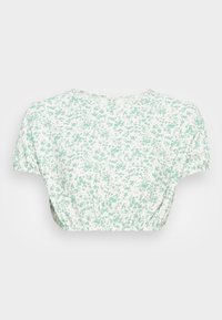 Kvetinový crop top s krátkymi rukávmi, vyrobený z ľahkého materiálu. S bielym základom a malým zeleným kvetinovým vzorom a gumičkovým pásom.