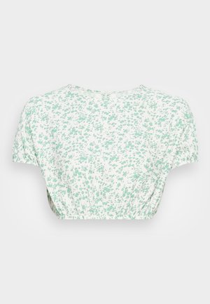 Ziedu apgrieztais tops ar īsām piedurknēm, izgatavots no viegla auduma. Balta pamatne ar mazu zaļu ziedu rakstu un savelkamu jostas detaļu.