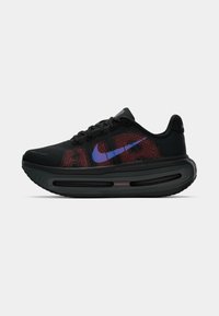 Sneaker sportiv negru cu accente roșii și albastre, superior din plasă, suprafață texturată și o talpă cu sistem de amortizare vizibil.