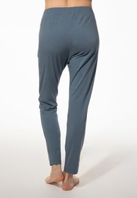 Zachte, rekbare, blauw-grijze broek met een strakke tailleband en taps toelopende pijpen, gemaakt van lichtgewicht materiaal. Geen zichtbare patronen of accenten.