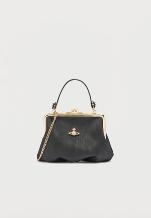 Small black handbag with gold frame, chain strap, top handle, and a gold orb logo centered on the front.