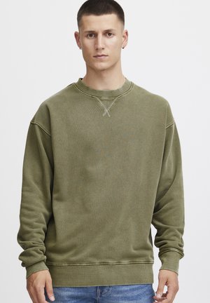 Olive green sweatshirt with long sleeves, crew neckline, and ribbed cuffs. Features textured fabric and subtle stitching detail on neckline.