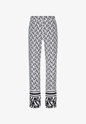 Zwart-witte rechte broek met patroon van abstracte geometrische vormen en horizontale strepen bij de zoom.