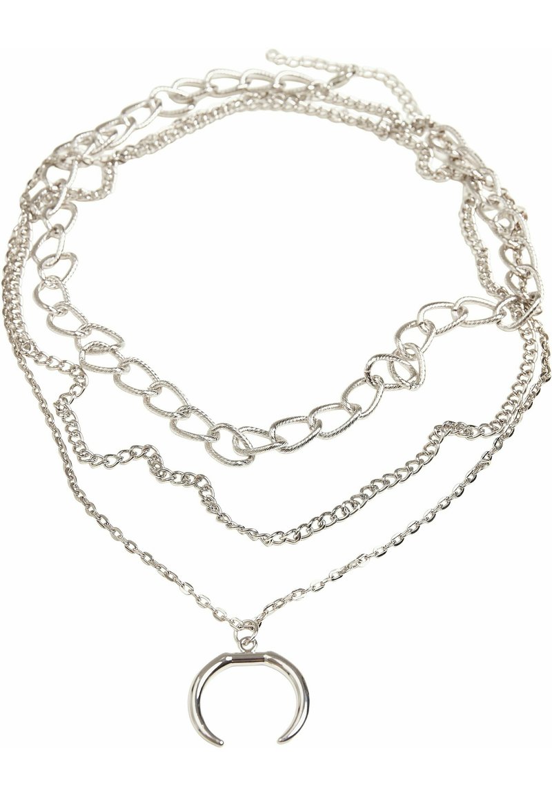 Collier argenté à plusieurs couches avec différents styles de chaînes, y compris des chaînes liées et délicates, portant un pendentif en forme de U.