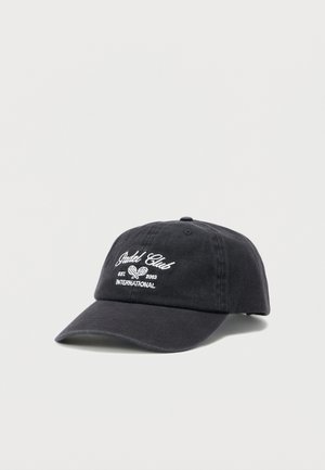 Black baseball cap with white embroidered text "Jadel Club Est 2043 International" and two crossed tennis rackets on front panel.
