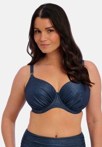 Námořnická modrá podprsenka bikiny s kosticemi, s texturovanou tkaninou, řasením a zlatým detailem na ramínku. Klasický tvar košíčků a nastavitelné ramínka.