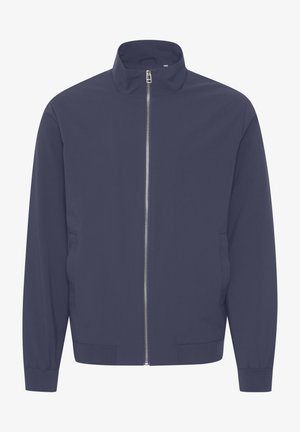 Marinblå jacka med hög krage, fullständig dragkedja fram, långa ärmar och elastiska manschetter. Slät textur, inga synliga mönster eller detaljer.