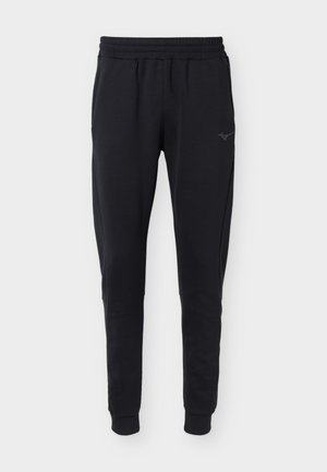 Zwarte taps toelopende joggingbroek met elastische tailleband en boorden, zijzakken en een subtiel logo op de linker dij.
