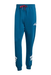 Blue sweatpants with a drawstring, featuring white Adidas logos and three stripes on the lower legs. Smooth texture, tapered fit at ankles.