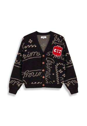 Black cardigan featuring cream textural patterns, red dollar sign patch, and wooden buttons. Soft knit material with a relaxed fit.