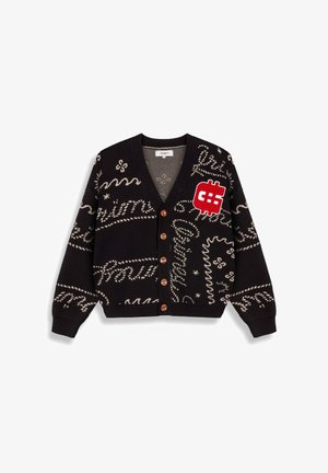 Cardigan negro con patrones texturales en crema, parche de signo de dólar rojo y botones de madera. Material de punto suave con un corte relajado.