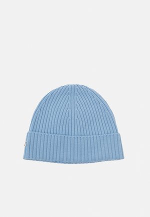 Light blue knitted beanie hat with a ribbed texture, featuring a folded cuff and subtle logo detail on the side.
