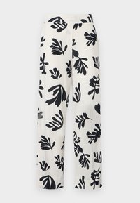 White linen pants featuring a bold black botanical print, wide legs, a relaxed fit, and stitched pleats on the front.