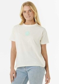 T-shirt in cotone color crema con maniche corte e scollatura rotonda, caratterizzato da un motivo circolare leggermente blu sulla parte anteriore.