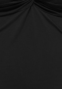 Tissu noir avec un détail froncé et plissé au centre supérieur, créant des plis doux et une texture.