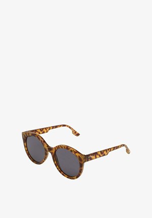 Lunettes de soleil en écaille de tortue avec des verres ronds, des verres noirs et des motifs tourbillonnants distincts. Texture lisse avec des branches incurvées.