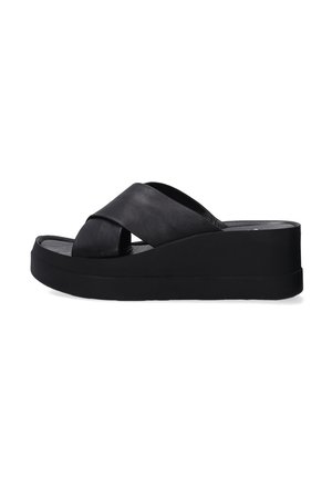 Black platform sandals with a cross-over strap design made from leather. Features a thick sole for added height and stability.