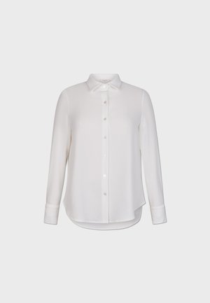 Camisa blanca de manga larga hecha de un tejido suave, con un cierre de botones en la parte delantera y un dobladillo curvado con mangas abotonadas.