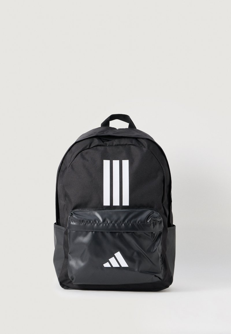Black backpack featuring a textured fabric, white three-stripe design, and a glossy front pocket with a logo accent. Round shape and top handle.