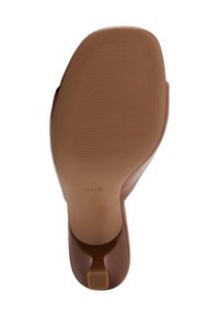 Brown shoe sole showing a smooth, glossy finish with ribbed texture, featuring a low heel and a rounded toe. Logo visible on the sole.